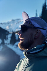 Man bearded runner in the winter mountains