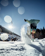 Man running at snow in the winter mountains
