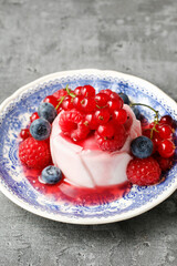 Panna cotta, italian dessert decorated with fresh red fruits.