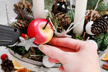 Florist at work: woman making traditional christmas decorations. Step by step, tutorial.