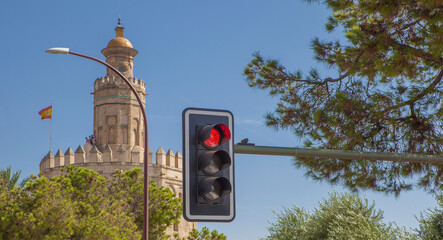 Red traffic light with the Torre del Oro of Seville