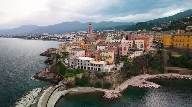 Dynamic Aerial Drone Orbit Circling the Fortified Genoese Citadel and Historic Old Port of Bastia, Corsica, France, on the Overcast Mediterranean Coast.