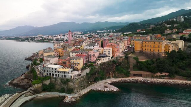 Smooth Aerial Drone Zoom Out Revealing Historic Genoese Citadel and Colorful Old Port of Bastia, Mediterranean Coast, Corsica, France.