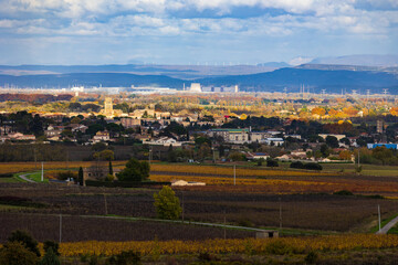 Tricastin nuclear power plant on the horizon with its cooling towers under reconstruction, seen from the village of Saint-Alexandre