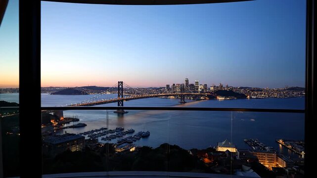 4k, Evening view of skyline and the Bay Bridge from an elevated vantage point hotel room with cinematic lighting and a calm, blue color palette, framed by