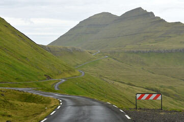 An empty, lonely, narrow road in the Faroe Islands