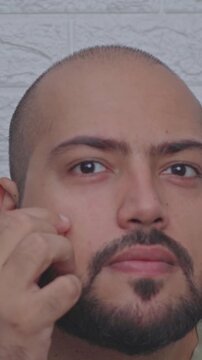 Vertical Video of Man Applying Pimple Patch on Face