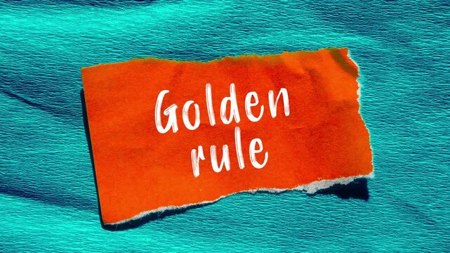 Golden rule message writing on ripped torn paper background