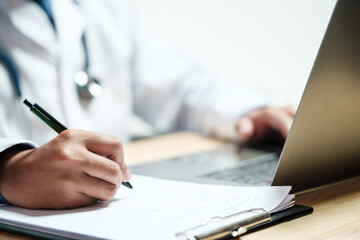 Doctors and nurses for medical concepts, health insurance, family health benefits access and copy space. Doctors diagnose diseases on document and computers.