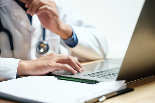 Doctors and nurses for medical concepts, health insurance, family health benefits access and copy space. Doctors diagnose diseases on document and computers.