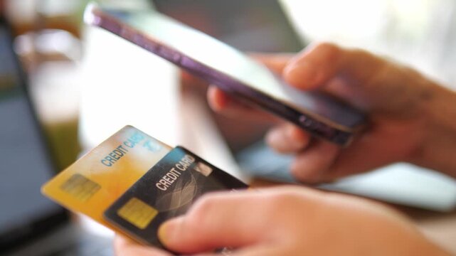 Hands Holding Credit Cards and Smartphone for Online Payment &ndash; Digital Banking, E-Commerce, Fintech 4K Footage
