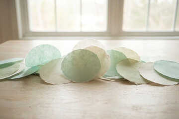 Pastel Paper Circles on Wooden Table