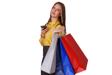 Young woman shopping, carrying colorful bags, checking phone, enjoying retail therapy and consumerism on transparent background