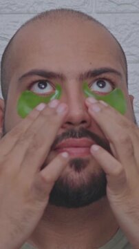 Vertical Video of Man Adjusting Eye Patchs
