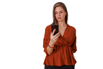 Woman holding smartphone with serious expression, standing and actively using mobile device, transparent background