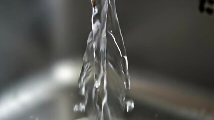 Clear Water Flowing From A Faucet Into A Sink With Subtle Bubbles And Refractions Of Light Creating A Mesmerizing Effect