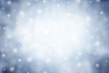 Magical winter background with snow, snowflakes and soft bokeh lights on blue sky, cold backdrop for Christmas.