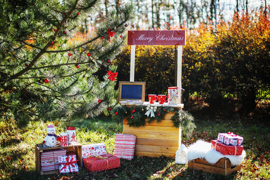 Christmas themed scene in nature with presents garlands mugs and seasonal decorations perfect for advertising holiday events and family celebrations