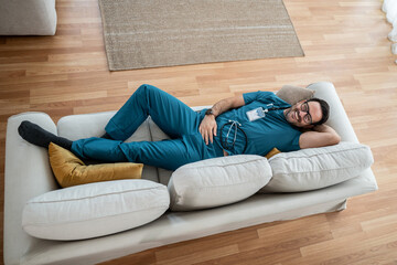 Doctor taking a nap on couch feeling tired after work