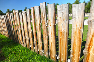 Wooden fence made of planks on the farm.