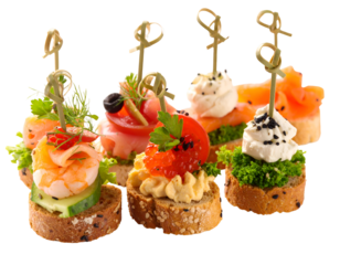 Assorted gourmet canapés featuring various toppings on small bread bases with decorative picks