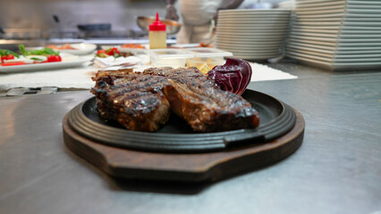Delicious beef steak meal being eaten at fine dining restaurant during evening dinner