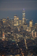 Fototapeta premium Night aerial photography of Manhattan skyline with glowing buildings and bustling streets