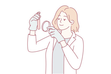 Caucasian woman disinfecting gadget with spray and cloth, preparing headset for remote meeting. Soft line-art portrait shows focused homeowner smiling while applying sanitizer to device,