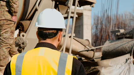 A construction foreman conducts an inspection at a construction site