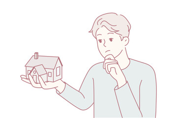 Man holding miniature house looking worried about mortgage and future planning, concerned expression with property and finance context, homeownership stress theme, muted palette and contemplative mood