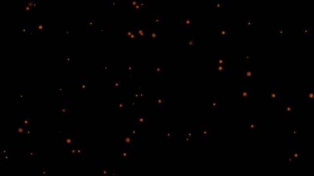 Rote Funken, die langsam ins Rechte fliegen, isoliert auf schwarzem Hintergrund.