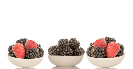 Sweet raspberries and blackberries isolated on white background, macro.
