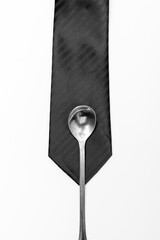 A black tie and a spoon