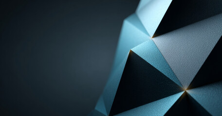 Close-up of textured geometric shapes with triangular facets in blue tones against dark background
