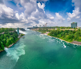 Scenic view of Niagara Falls in summer with lush greenery and flowing waterfalls