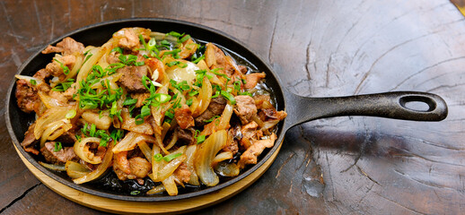 original fajita sizzling smoking hot served on iron plate ,with selection of beer and fresh vegetables on background ,MORE DELICIOUS FOOD ON PORTFOLIO. High quality photo