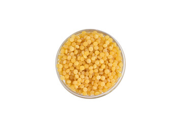Yellow bulgur grain lies in a round vase. View from above.