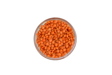 Red lentils in a round bowl, top view.
