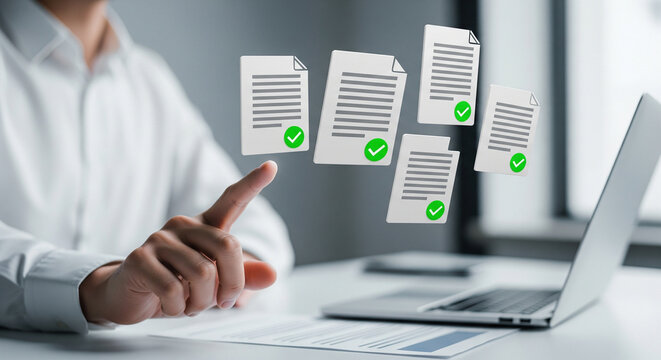 Business professional reviewing approved digital documents with laptop and finger pointing upwards