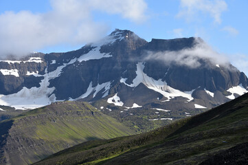 Mountain peaks covered with snow, summer in Iceland.