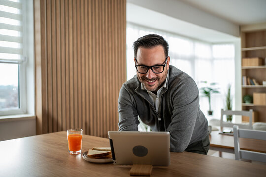 Man having breakfast video call at home remote work