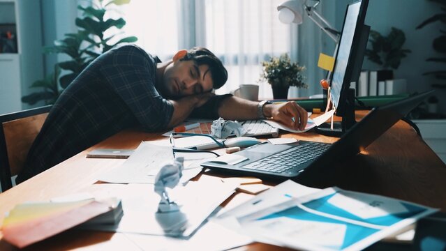Skilled interior designer work on palettes and crumpled paper. Top view of skilled business man run out of idea while sleeping at meeting table. Project manager crumpled and throw paper. Symposium.