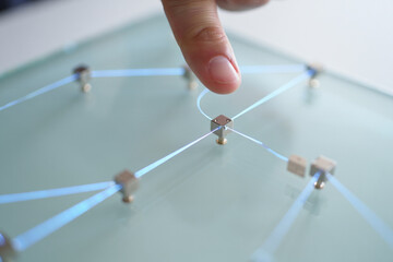 Person Touches Square Node on Network of Glowing Lines Interconnected on Glass Surface in Concept of Modern Communication and Futuristic Technology