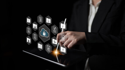 A businessperson interacts with a digital interface showcasing cloud security elements on a tablet, highlighting the importance of cybersecurity in contemporary technology. Gantry