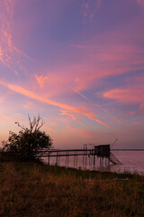 Fototapeta premium Traditional fishing hut at sunset creating a peaceful view