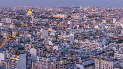Obraz premium Aerial panorama above houses rooftops in a Paris day to night timelapse