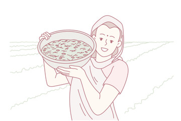 woman holding basket of harvest on shoreline fields, coastal agricultural scene with sea breeze and manual