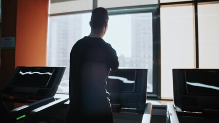 Shot of adaptive fitness in action. An athlete with a limb difference works on lower body strength using a leg press machine, assisted by a personal trainer. Highlights accessibility and determination