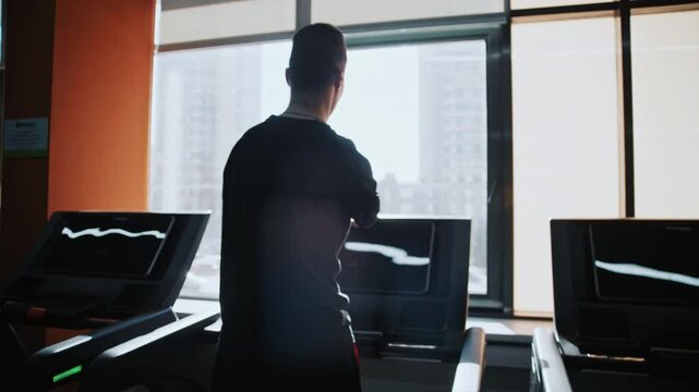 Shot of adaptive fitness in action. An athlete with a limb difference works on lower body strength using a leg press machine, assisted by a personal trainer. Highlights accessibility and determination