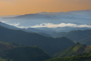 Fototapeta premium Mountain range mist sunrise forest valley landscape peaceful nature scenic morning